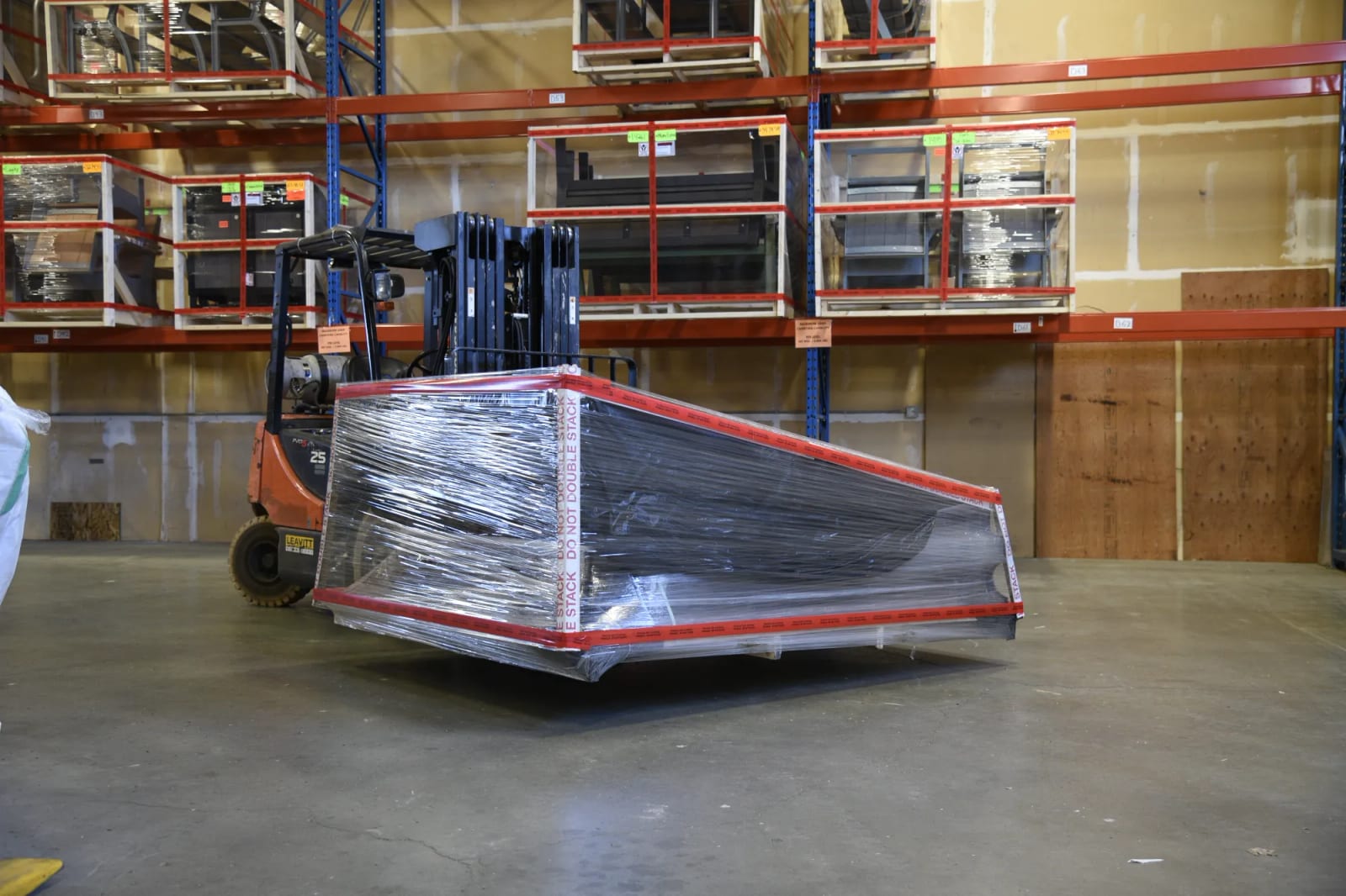 A wrapped Forest Series building leaving the warehouse on a forklift