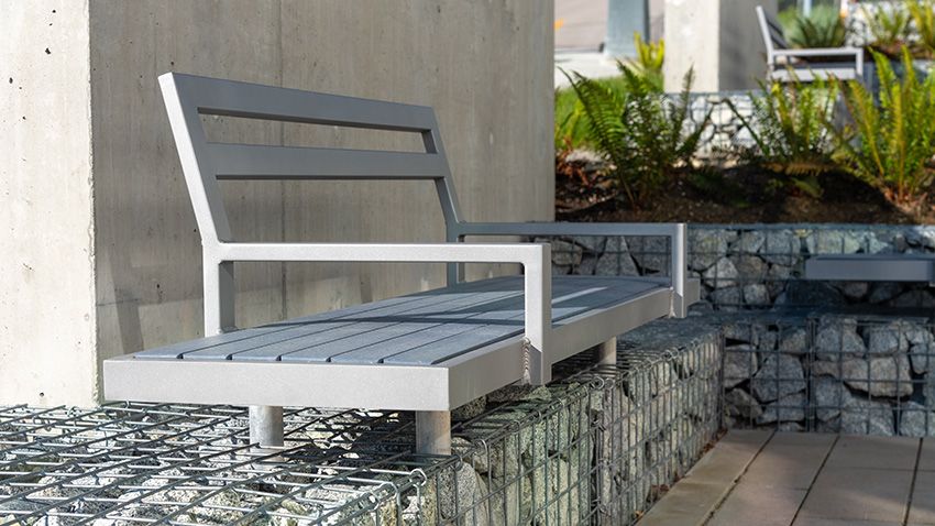 In the summer of 2019, Wishbone was called upon to supply in large quantity two types of benches for this high-profile school project: our Skyline and Skyline backless bench with a modification for installation as part of a gabion-cage wall feature.